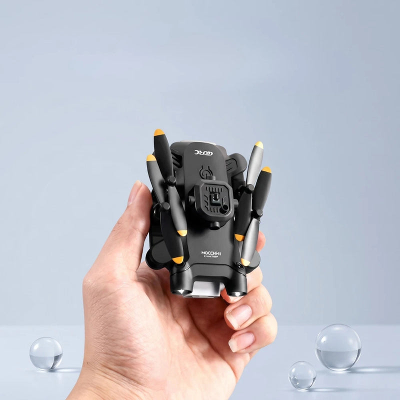 Mini FPV quadcopter drone with HD camera, black body and orange propeller tips