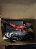 RC battery smart charger with black cables, red wires, and connectors in box