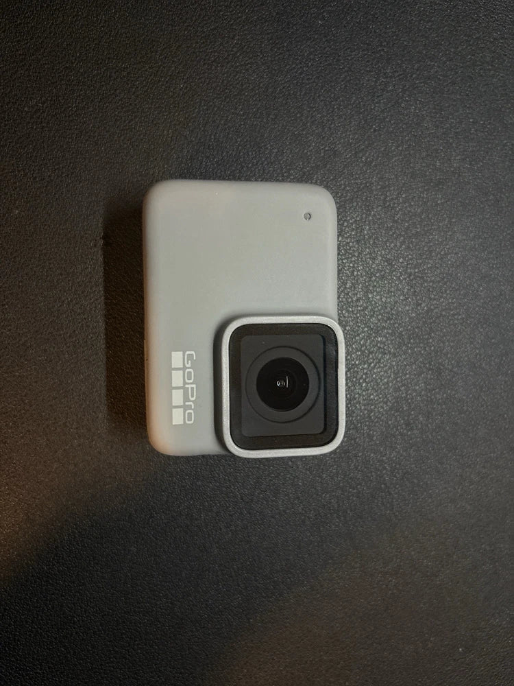 White GoPro HERO7 action camera with front lens and gray protective frame