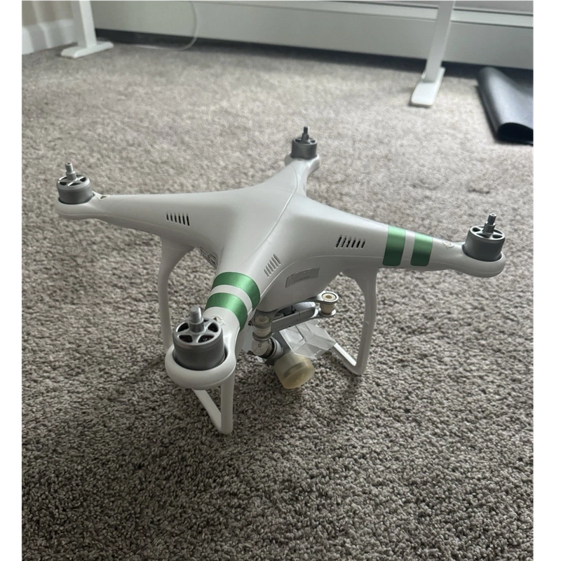 White quadcopter drone with green stripe arms and four propellers