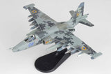 Gray camouflage Su-25M1 jet model with blue tail marking 08 and yellow emblem, on stand