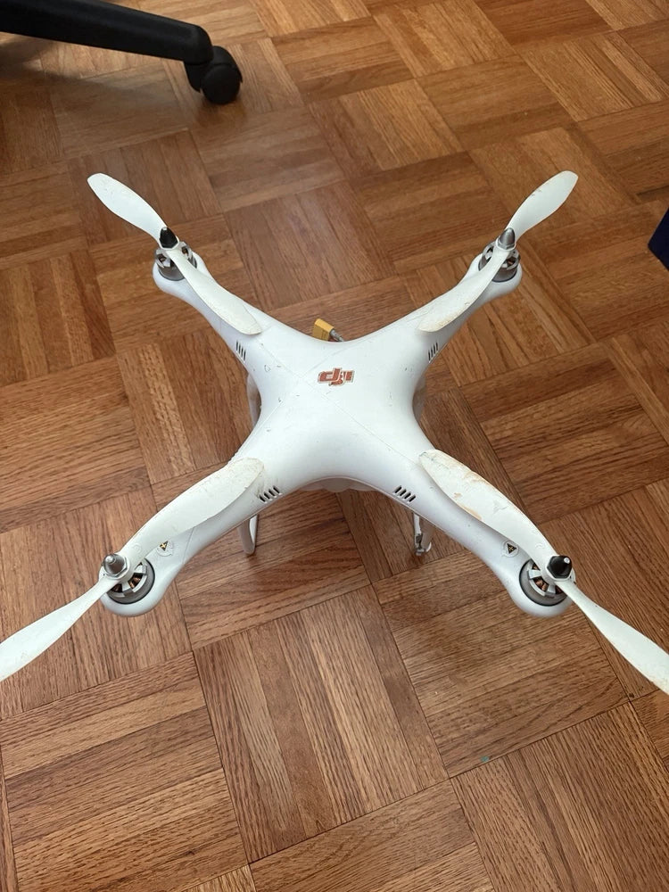 DJI Phantom 1 quadcopter drone with four white propellers, top view