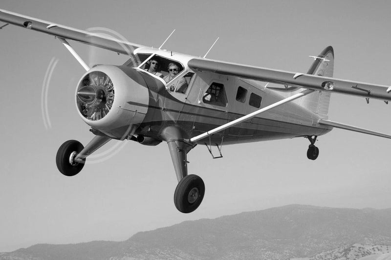 Light gray RC high-wing airplane model with propeller and landing gear