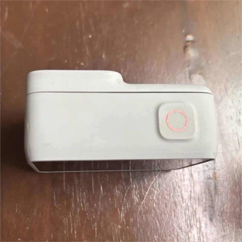 White action camera with side circular power button and red ring