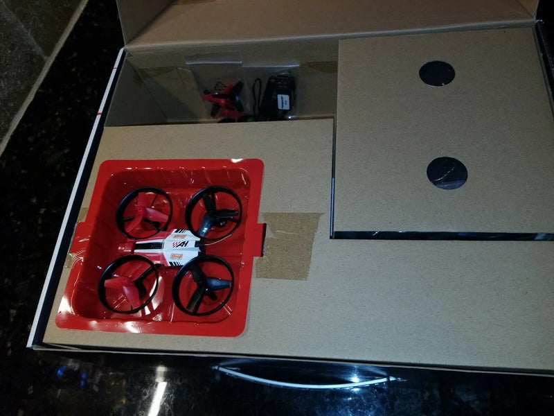 FPV race drone with four red propellers in red accessory tray