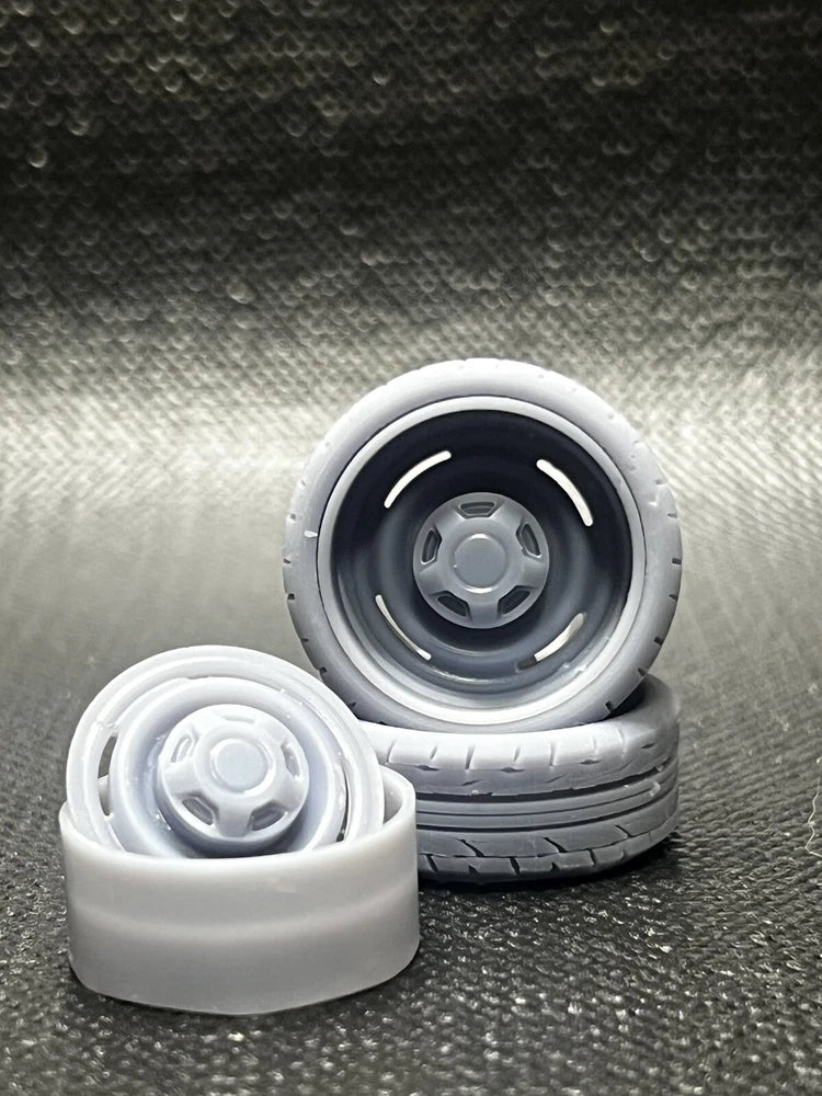 Resin dog dish style wheel set with gray hubs and black tires, two small scale wheels