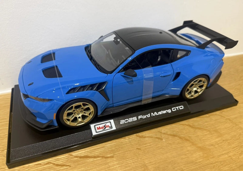 Maisto 1:18 die-cast blue 2025 Ford Mustang GTD model car on display base, gold wheels