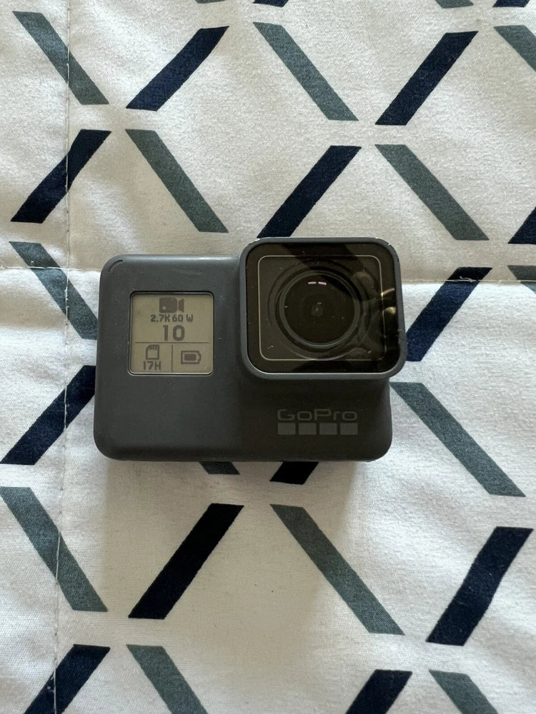 GoPro action camera with black housing and front lens, side screen visible