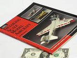 Scale model aircraft detailing hobby book with red-and-black cover and fighter jet photos