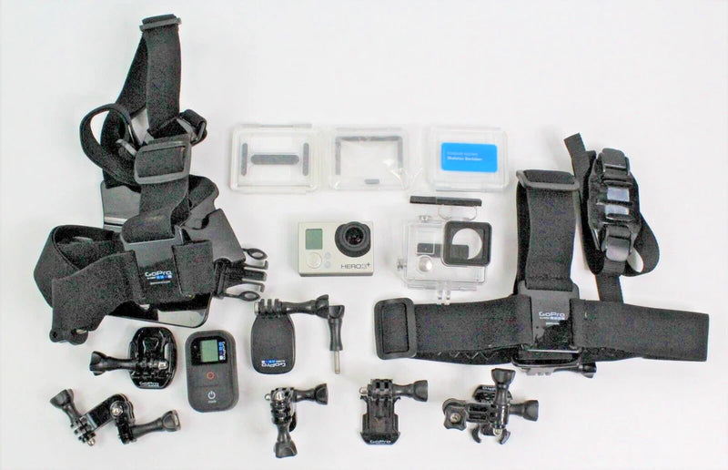 GoPro action camera accessories bundle with silver camera, mounts, straps, and cases