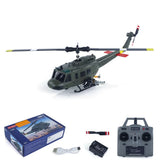 RC helicopter model with box and transmitter, dark green fuselage, tail rotor