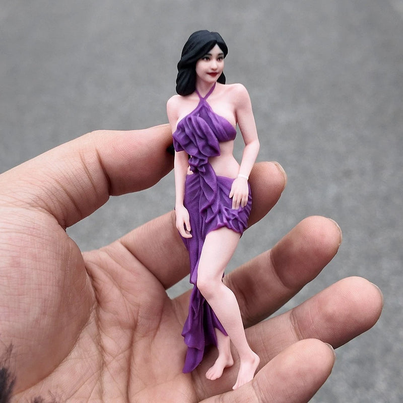 Miniature resin figure wearing a purple off-shoulder ruffled dress, full body