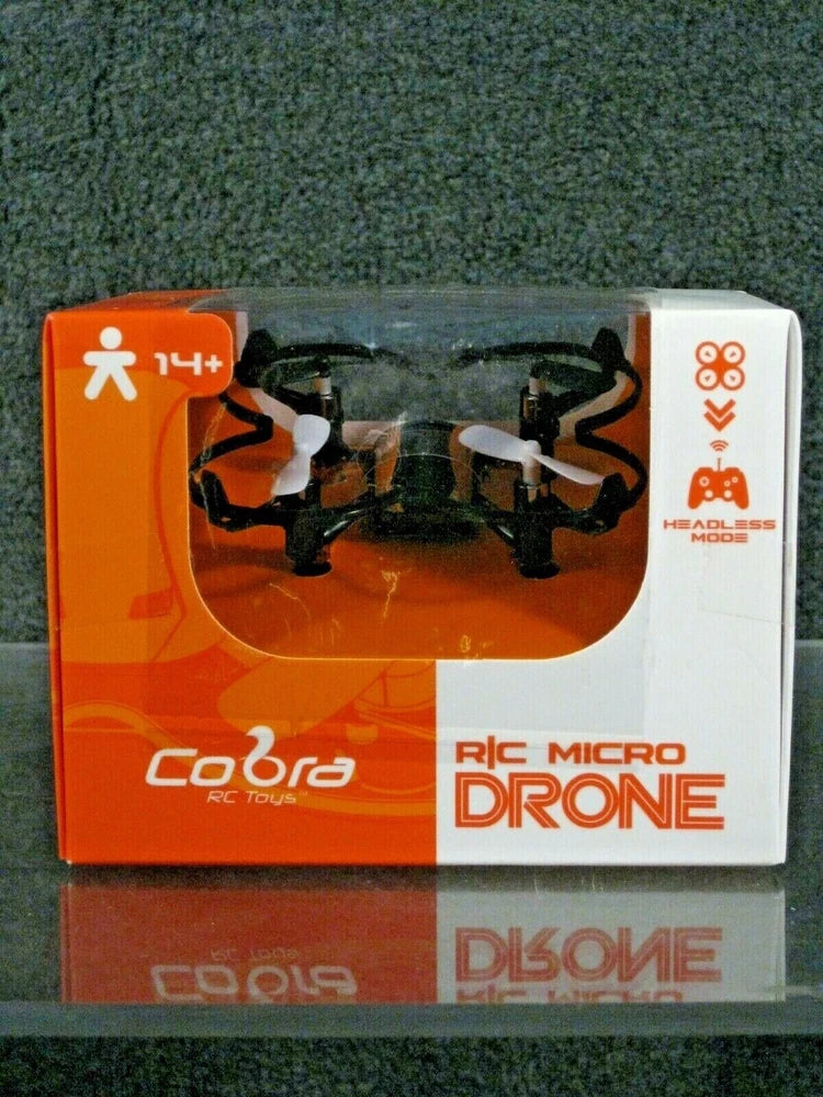RC micro drone-copter in retail box showing orange and black quadcopter