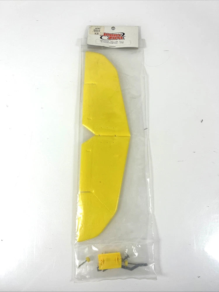 Yellow RC airplane replacement tail fin set in clear plastic packaging