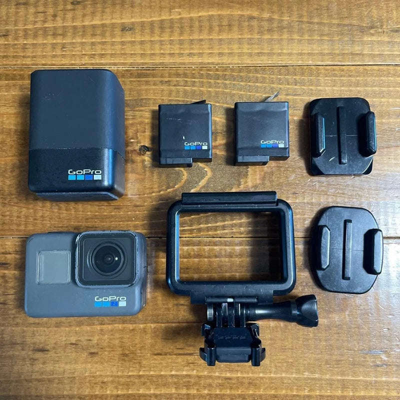 GoPro HERO6 Black action camera with waterproof housing and mounting accessories, shown top view