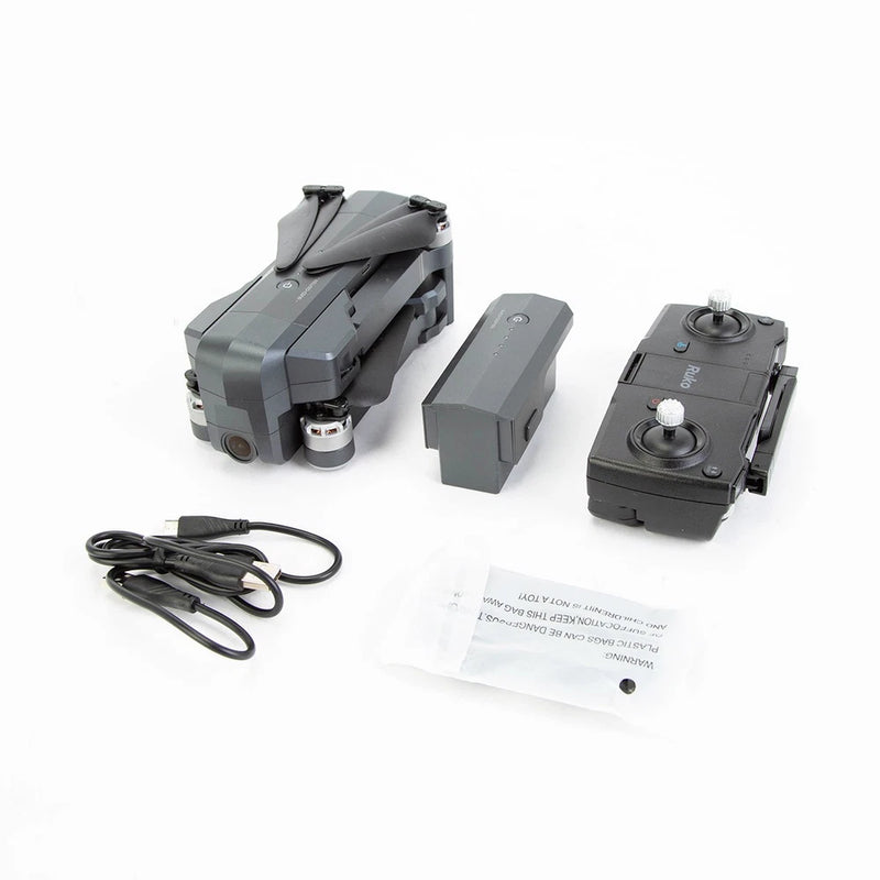 Gray quadcopter drone with spare battery, controller module, cables, and instruction sheet