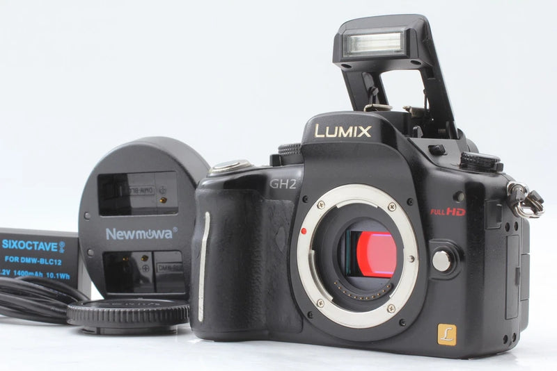 Panasonic Lumix DMC-GH2 digital camera body with lens and flash, black