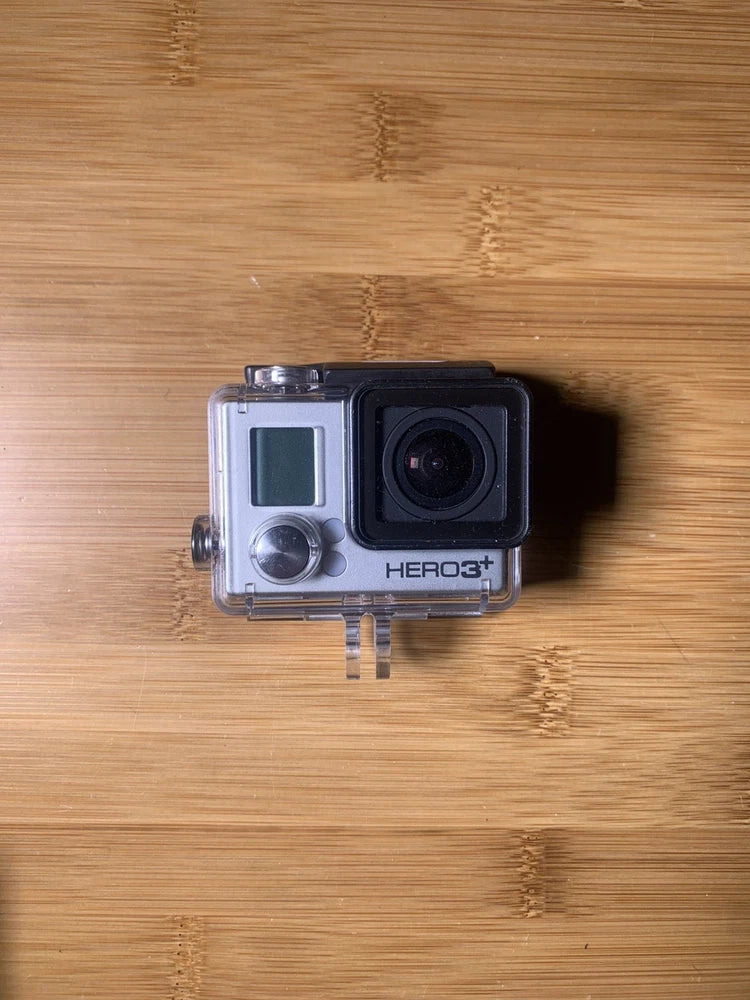 Black and silver action camera in clear waterproof case, visible HERO3+ branding