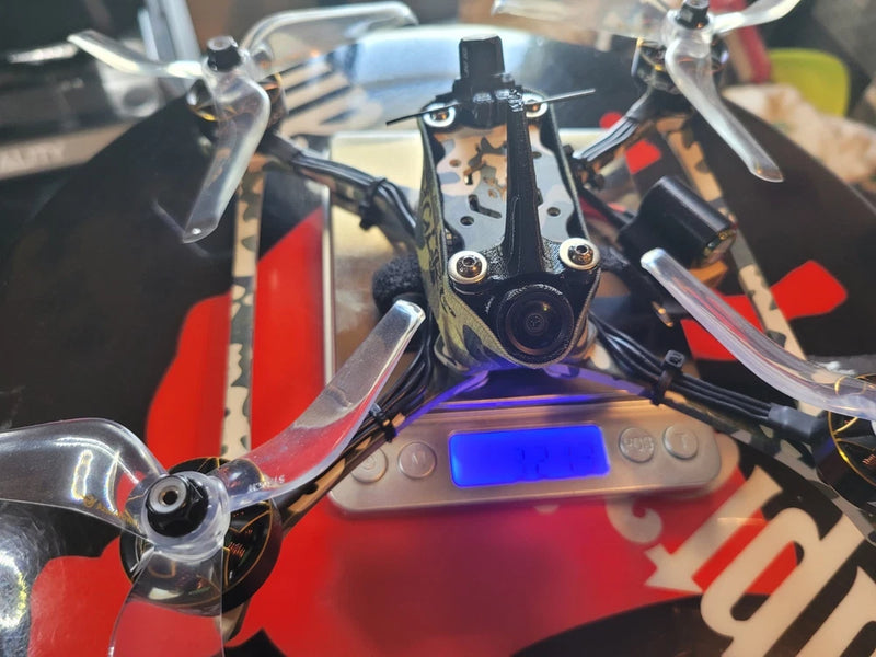 Camo FPV race drone with analog camera and four propeller arms