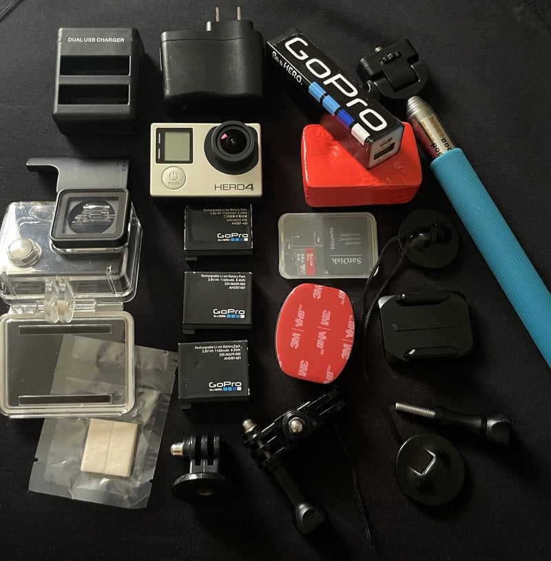 GoPro HERO4 Session action camera with lens and screen, plus assorted mounts and cases
