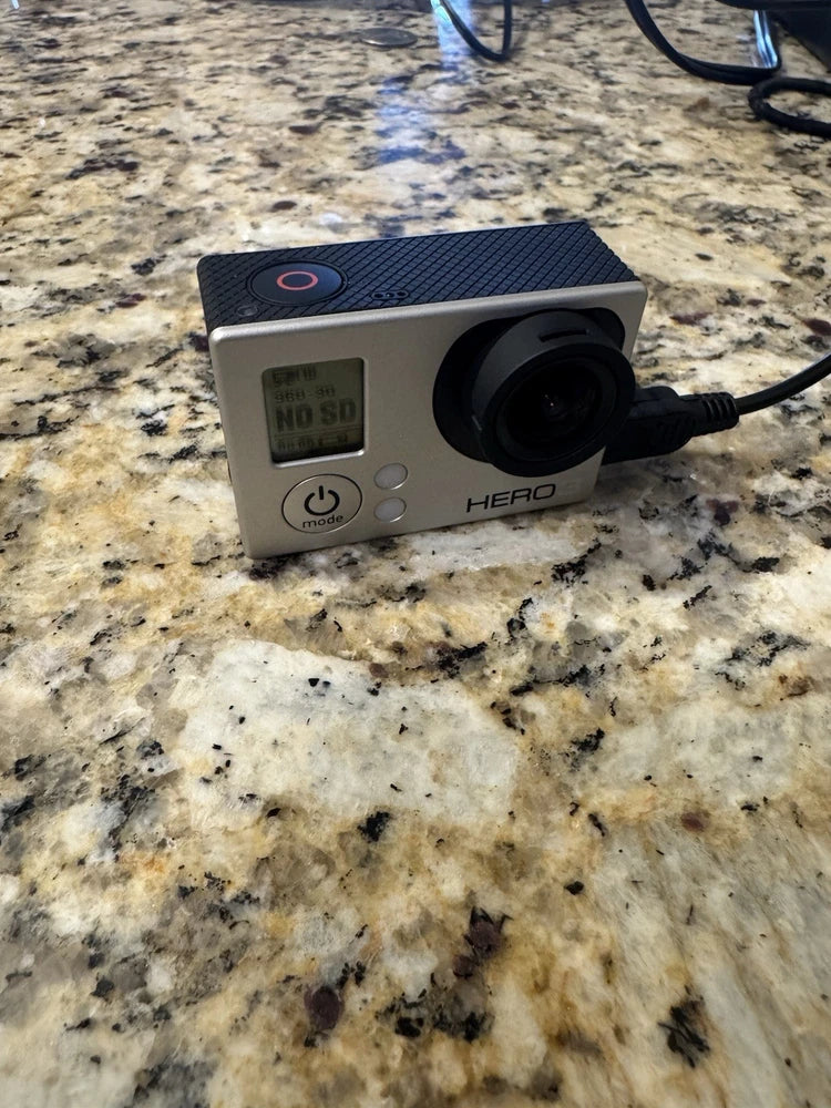 GoPro Hero3 action camera with front lens and small screen showing “NO SD”
