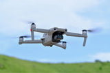 Gray quadcopter drone with front camera gimbal and four propellers