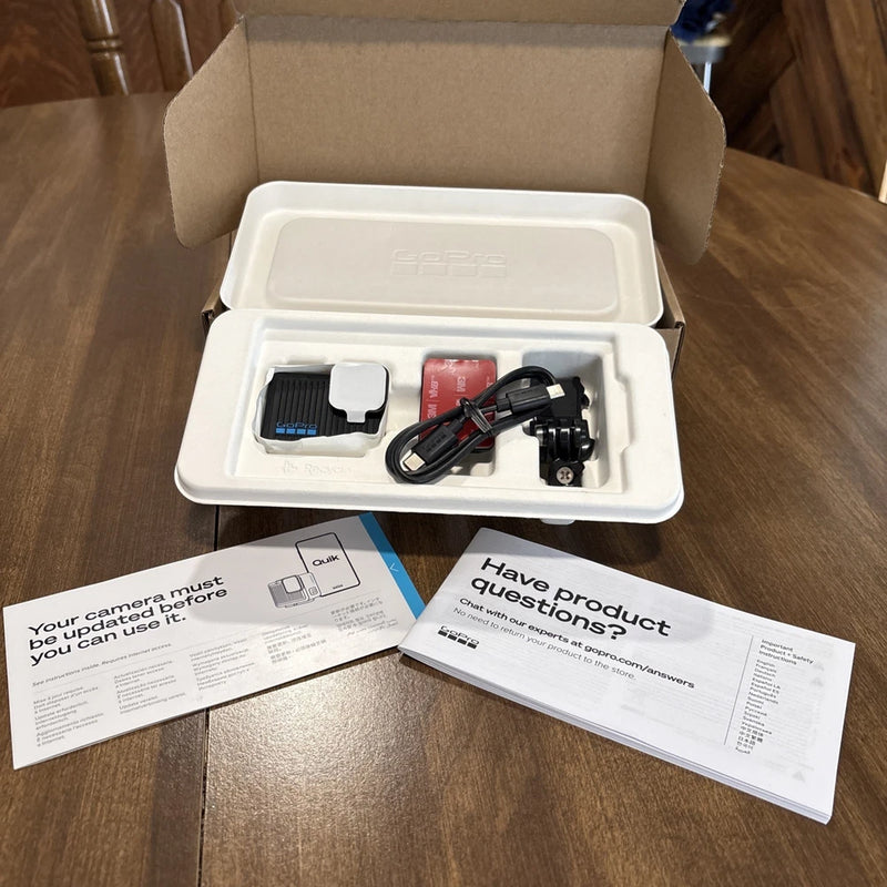 Compact action camera kit with camera, mounts, cables, and instruction manuals in case