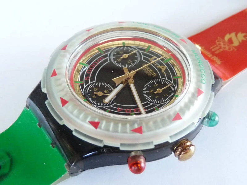 Analog wristwatch with black dial, gold-tone hands and clear case