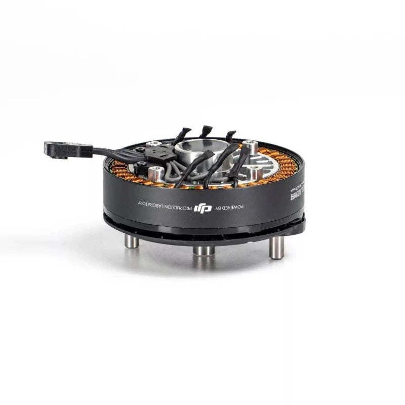 Brushless electric motor with black housing, orange coil windings, and wiring harness