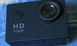 Black action camera with lens and HD 1080P label