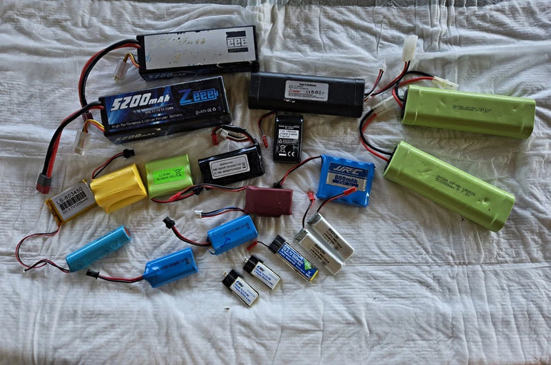 Assorted RC LiPo battery lot with 5200mAh packs, chargers, cables, and connectors