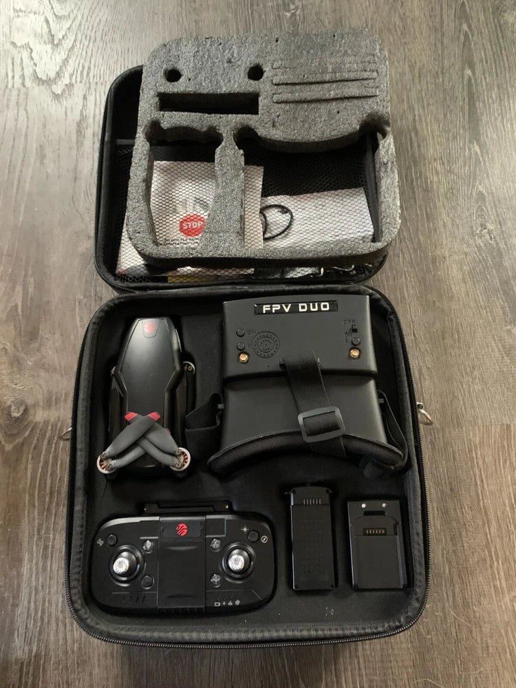 FPV racing drone kit in open hard case with controller and cables