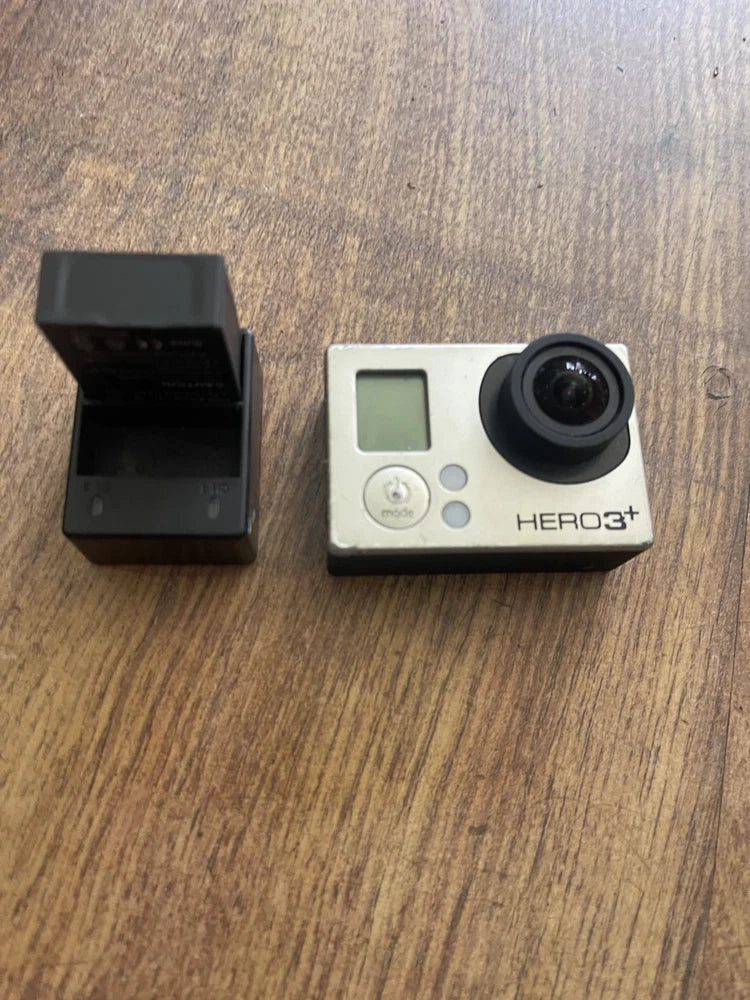 GoPro action camera with lens and spare battery and charger dock