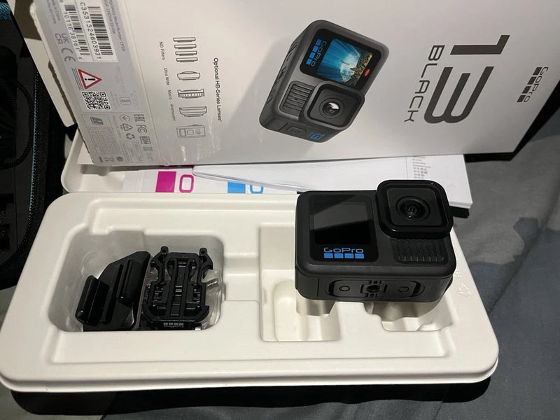 GoPro HERO13 action camera with front lens and side touchscreen in protective packaging