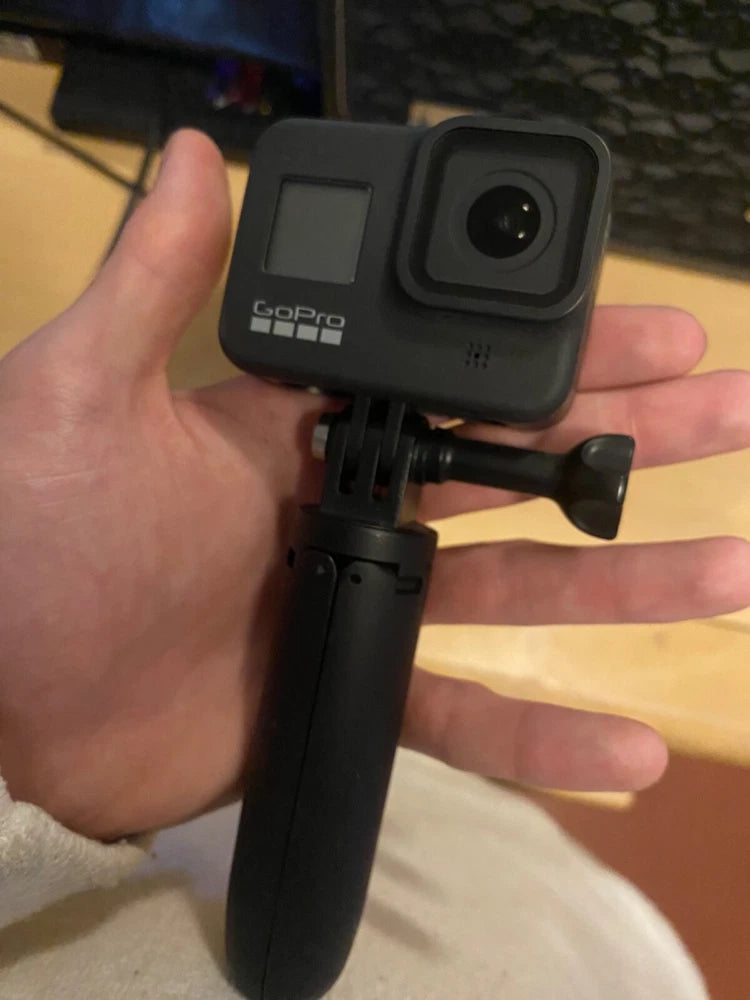 GoPro Hero 8 Black action camera with front lens and handle grip