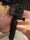 GoPro Hero 8 Black action camera with front lens and handle grip