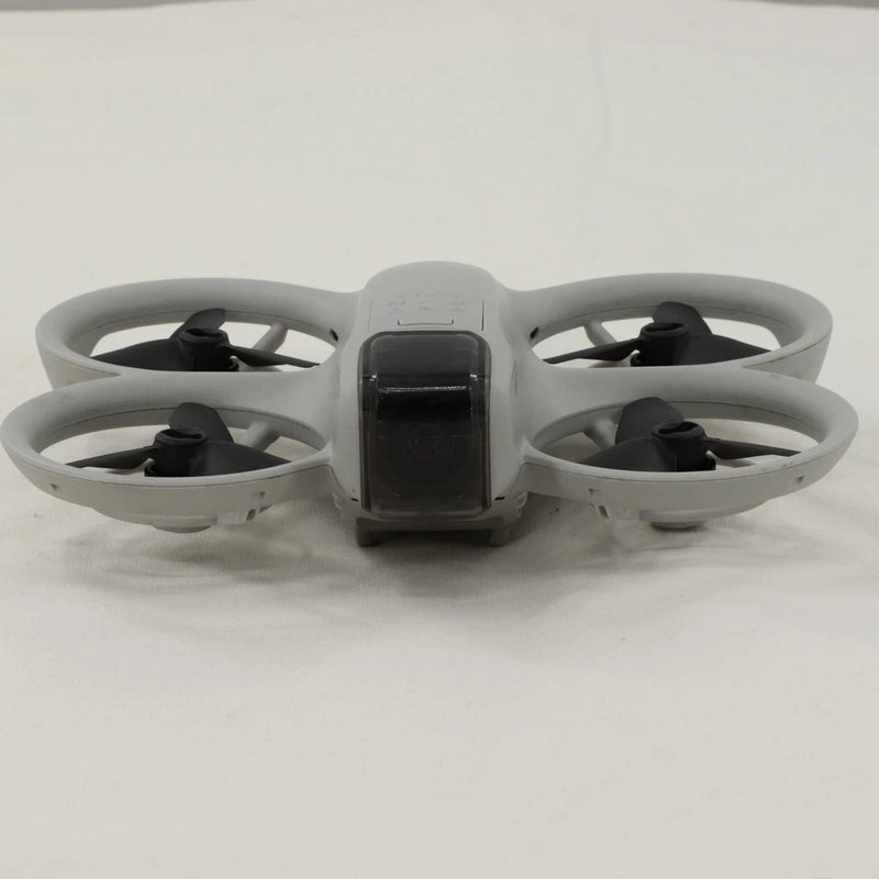 Gray quadcopter drone with front display and four black propellers