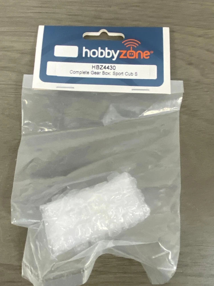RC airplane complete gear box in clear plastic bag with HobbyZone label