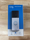 Ring speckled white battery doorbell with black camera and circular button, 2K video