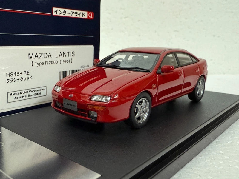 Red Mazda Lantis Type R model car on black base, front 3/4 view