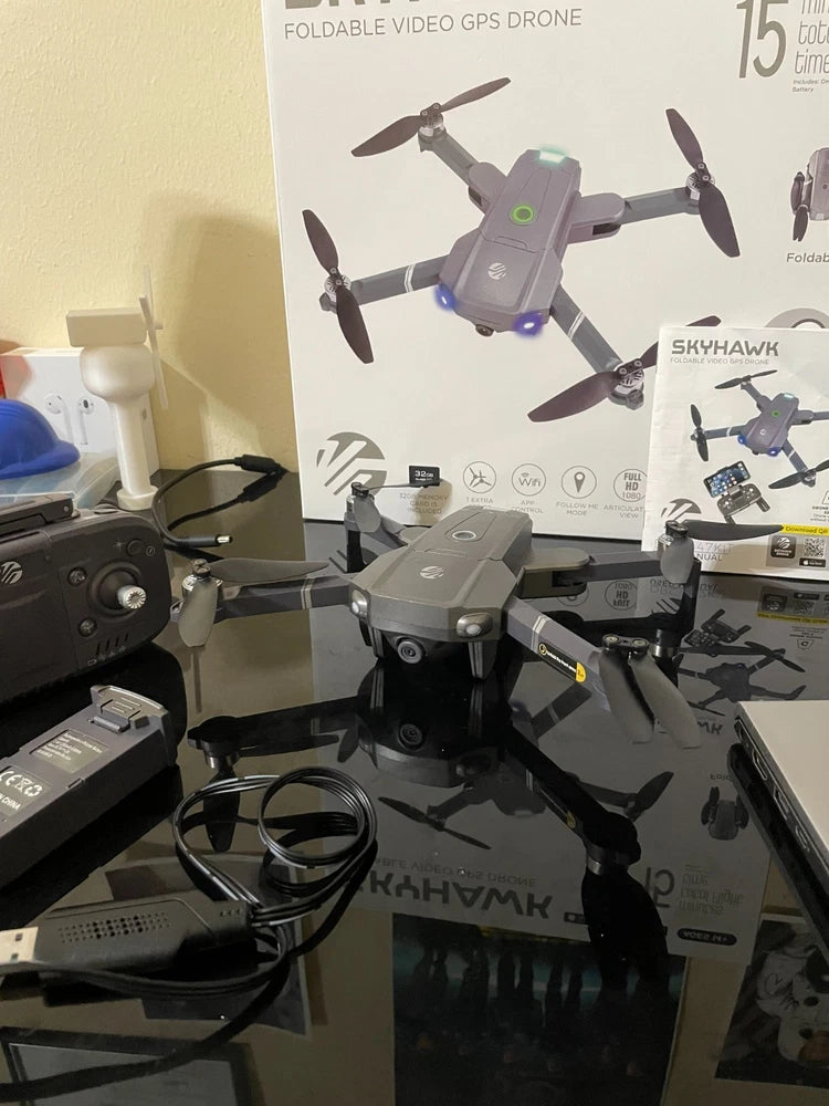 Foldable GPS video drone with guard rails, gray body, four propellers