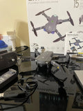 Foldable GPS video drone with guard rails, gray body, four propellers