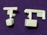 White plastic battery and washer bottle parts with mounting pegs for model kit