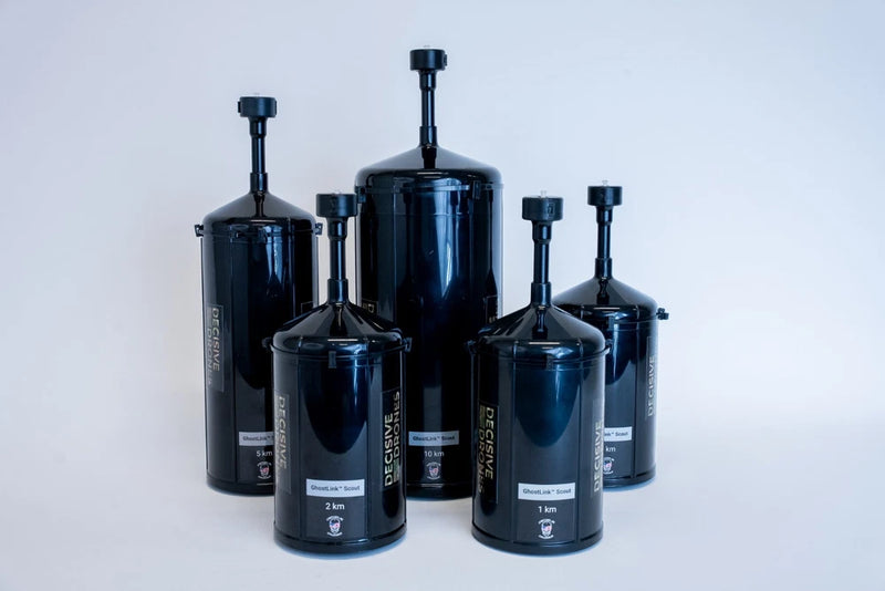 Set of dark cylindrical device canisters with valve stems and labels