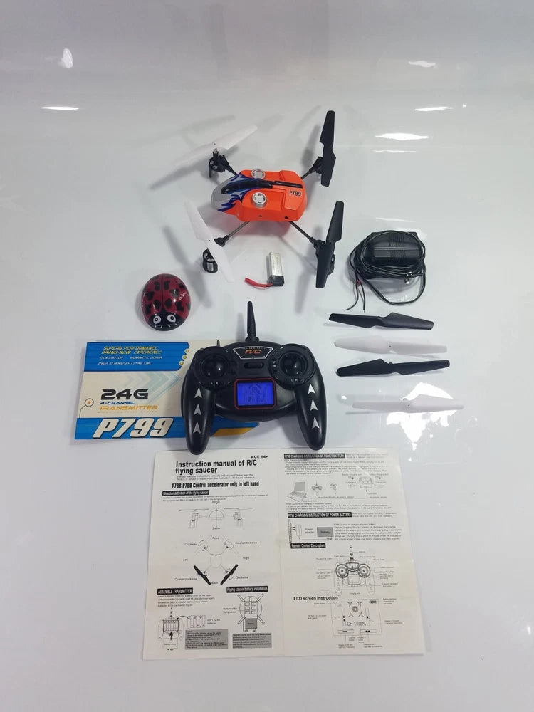 P799 quadcopter drone with orange body, 2.4G transmitter, spare blades, and manuals