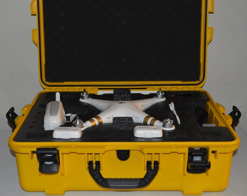 White quadcopter drone resting in open yellow hard case with foam inserts