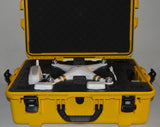 White quadcopter drone resting in open yellow hard case with foam inserts