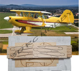 RC biplane airplane kit with yellow fuselage and laser-cut balsa/plywood parts on sheets