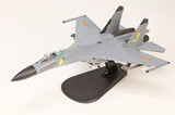 Grey 1/72 fighter jet model with wings and twin intakes on a display stand
