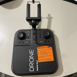 Black drone remote controller with two thumbsticks, buttons, and two antennas; Sharper Image